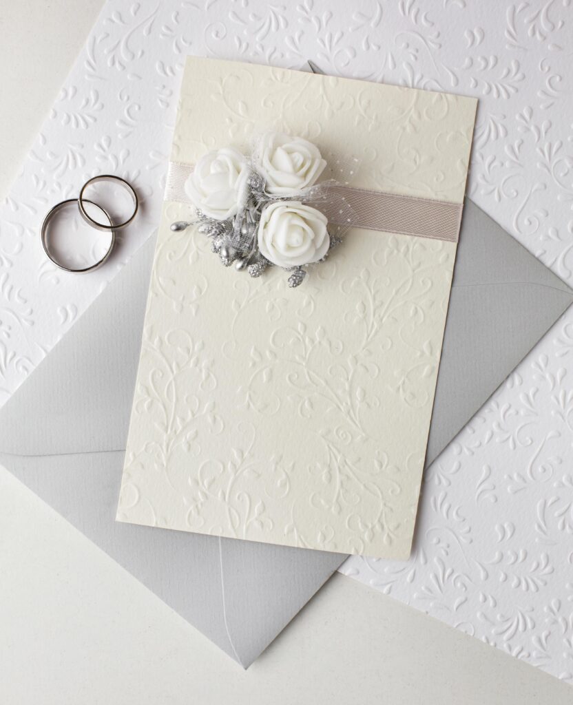 top view pastel coloured wedding invitations rings
