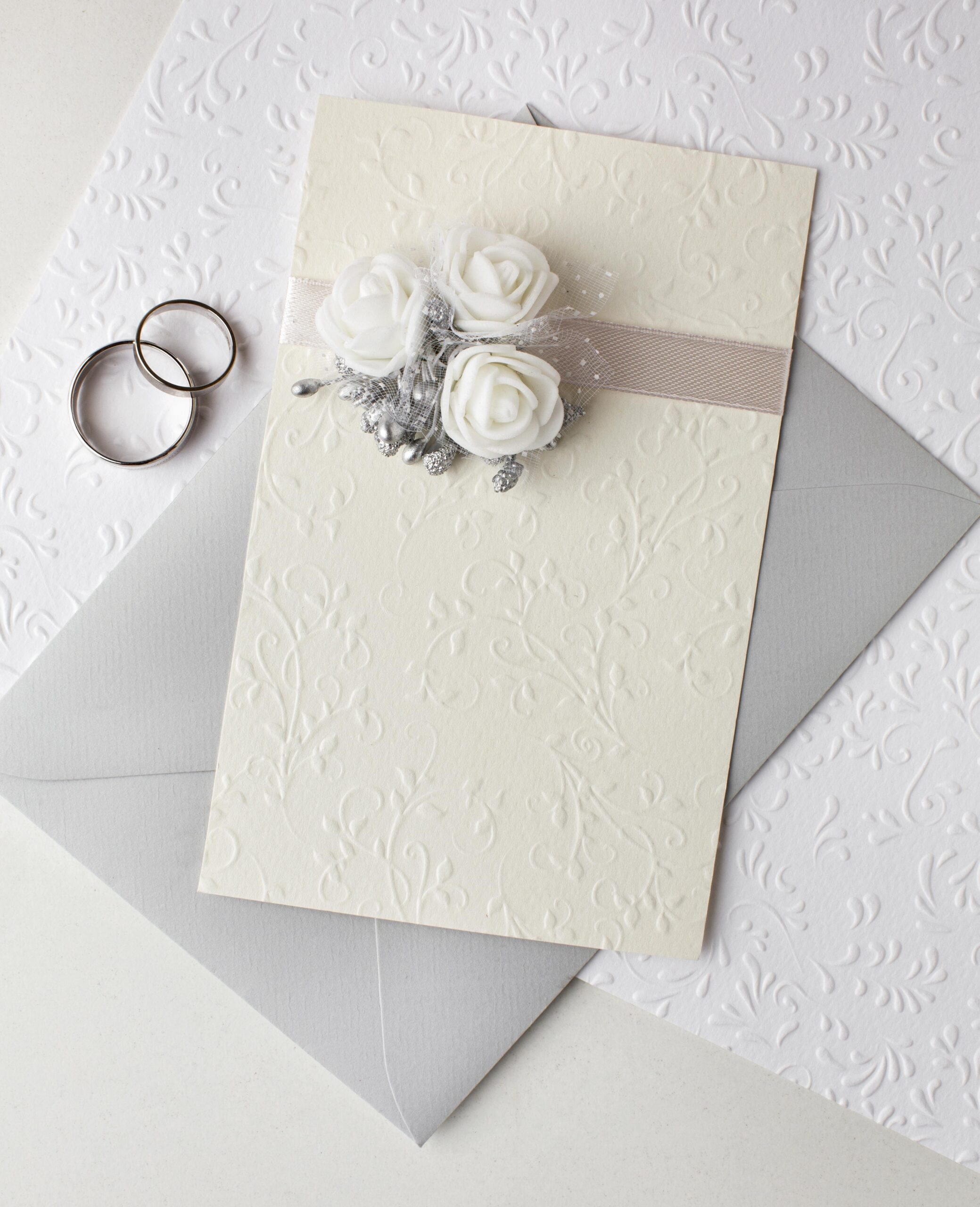 top view pastel coloured wedding invitations rings scaled