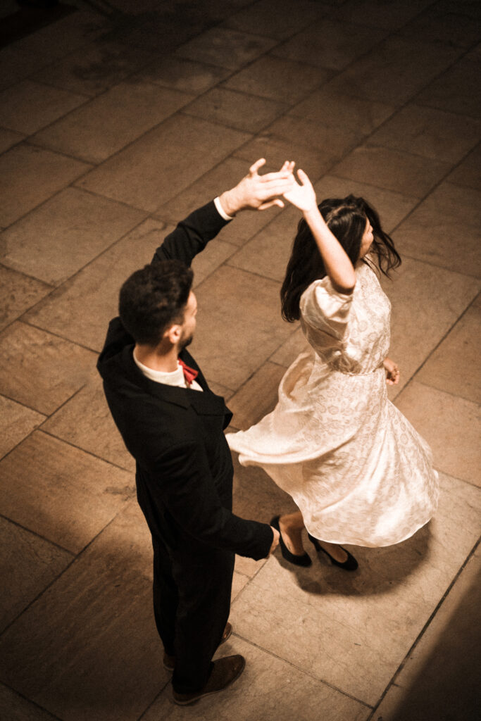 young man holding hand whirling elegant woman